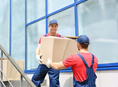 House removals in Millbank with moving boxes and city backdrop