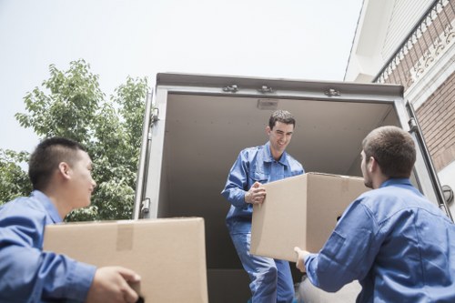 Packed household boxes and furniture ready for mobile storage in Millbank